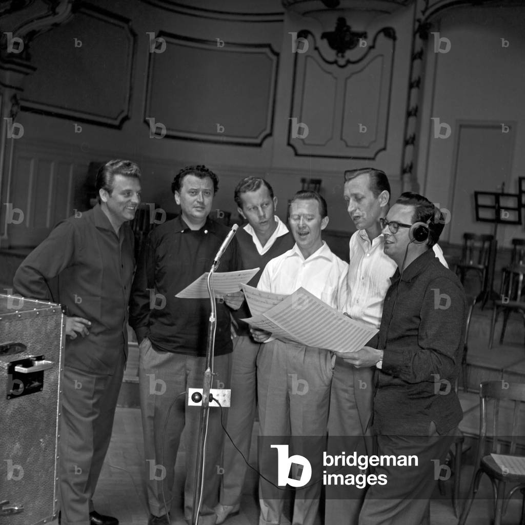 Singer Franco Duval (3rd from left) doing rehearsals in their hotel room at Berlin, Germany 1950s