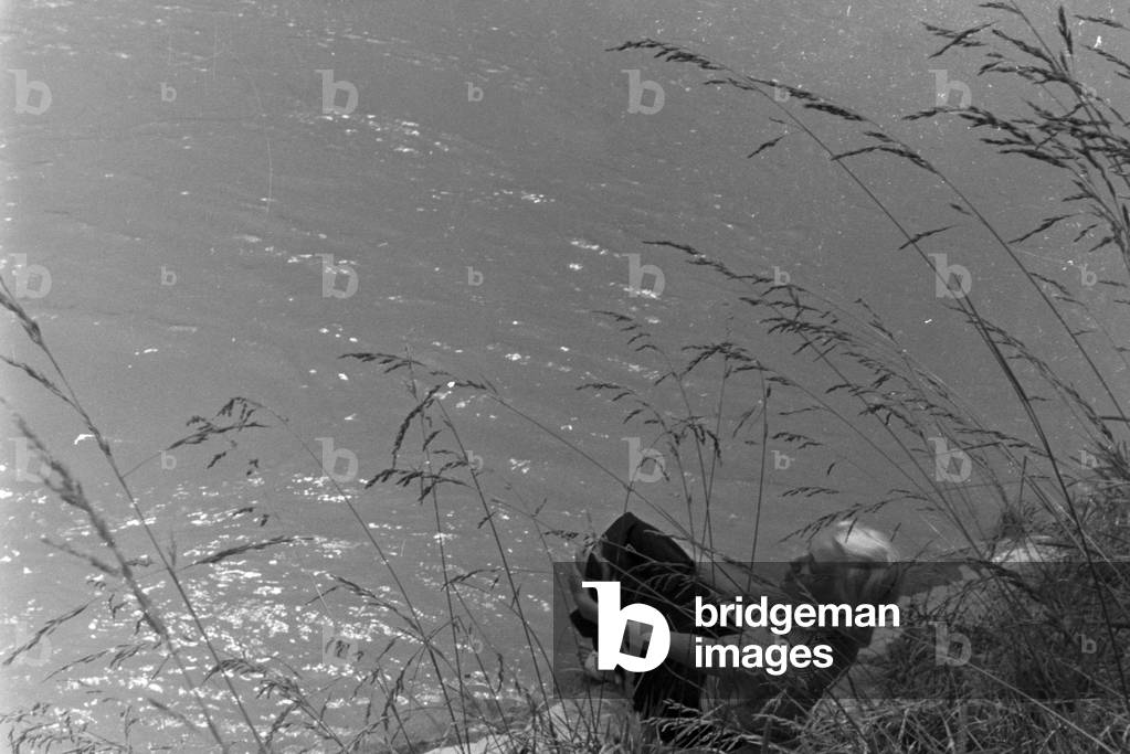 Young woman by a river, Germany 1930s (b/w photo)