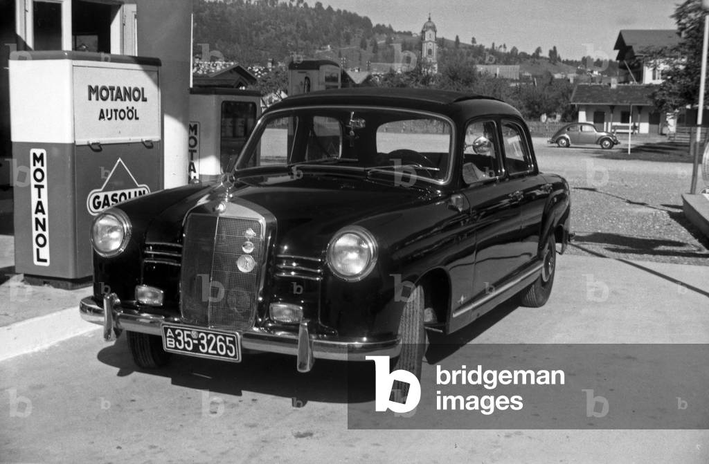 A Mercedes Benz Type W 121 at a petrol station, Germany 1950s (b/w photo)