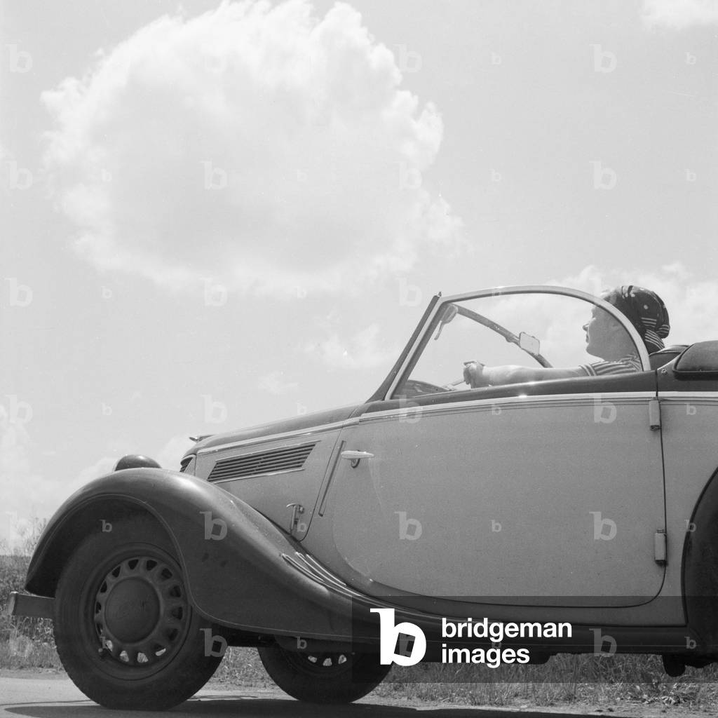A woman in her Ford model Eifel, Germany 1930s (b/w photo)