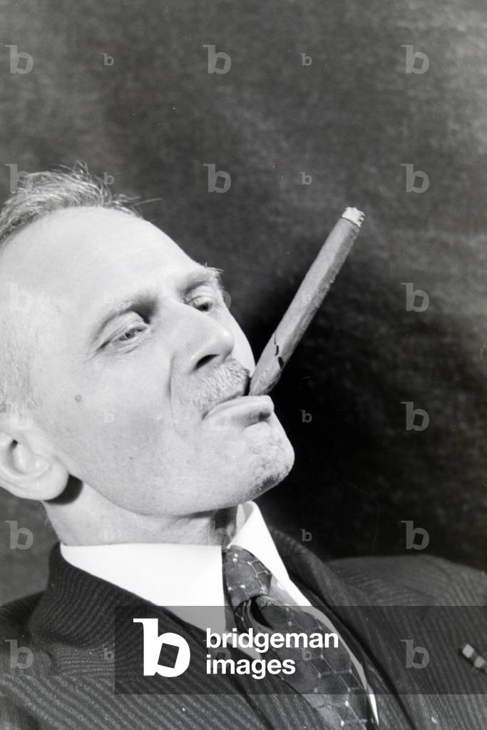A man smoking a cigar for an advertising campaign, Germany 1930s (b/w photo)