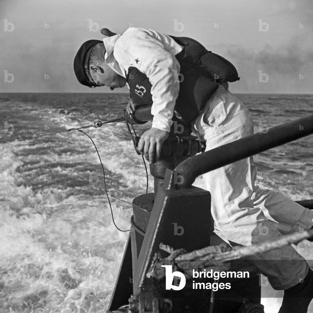 Sailor of a minesweeper at an exercise on his mindsweeper, Germany 1930s (b/w photo)
