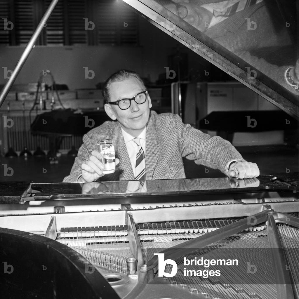 German pianist Roland Sander-Mahnken and his grand piano at Hamburg, Germany 1960s