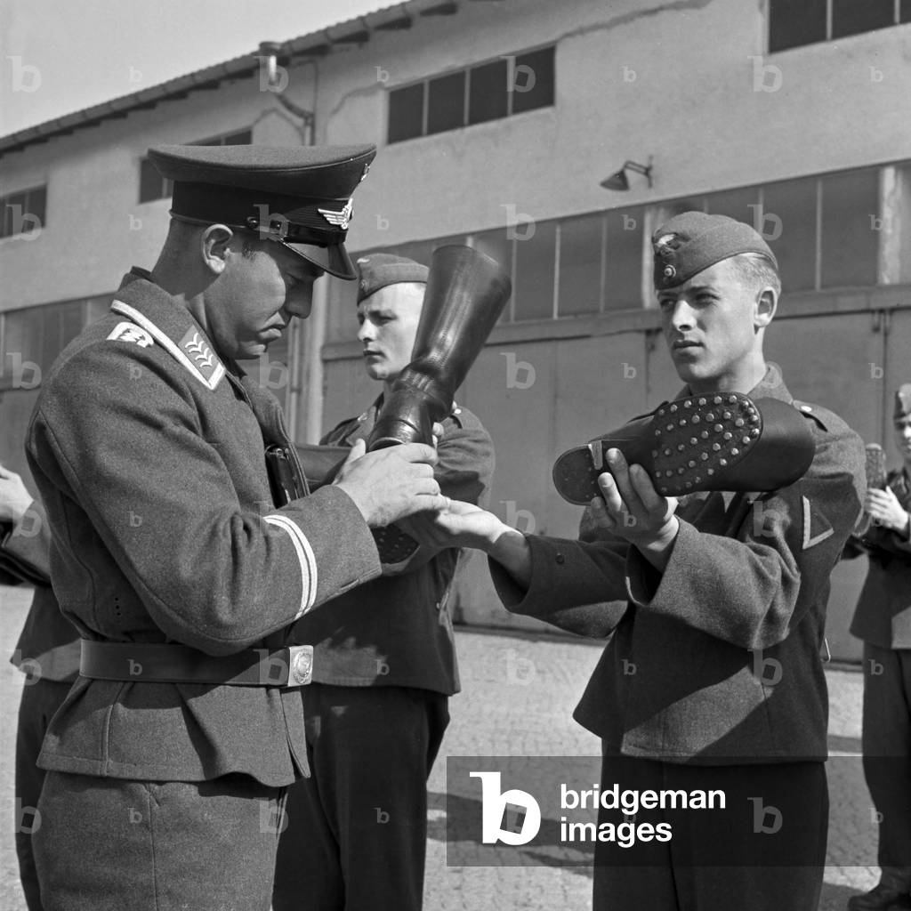 Boot mustering: kissem (staff sergeant) at his merciless control, Germany 1940s (b/w photo)