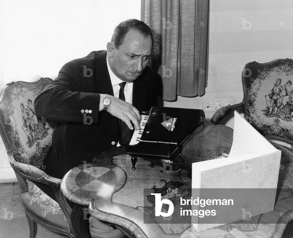 German radio and TV reporter Hermann Rockmann playing a toy piano, end 1950s