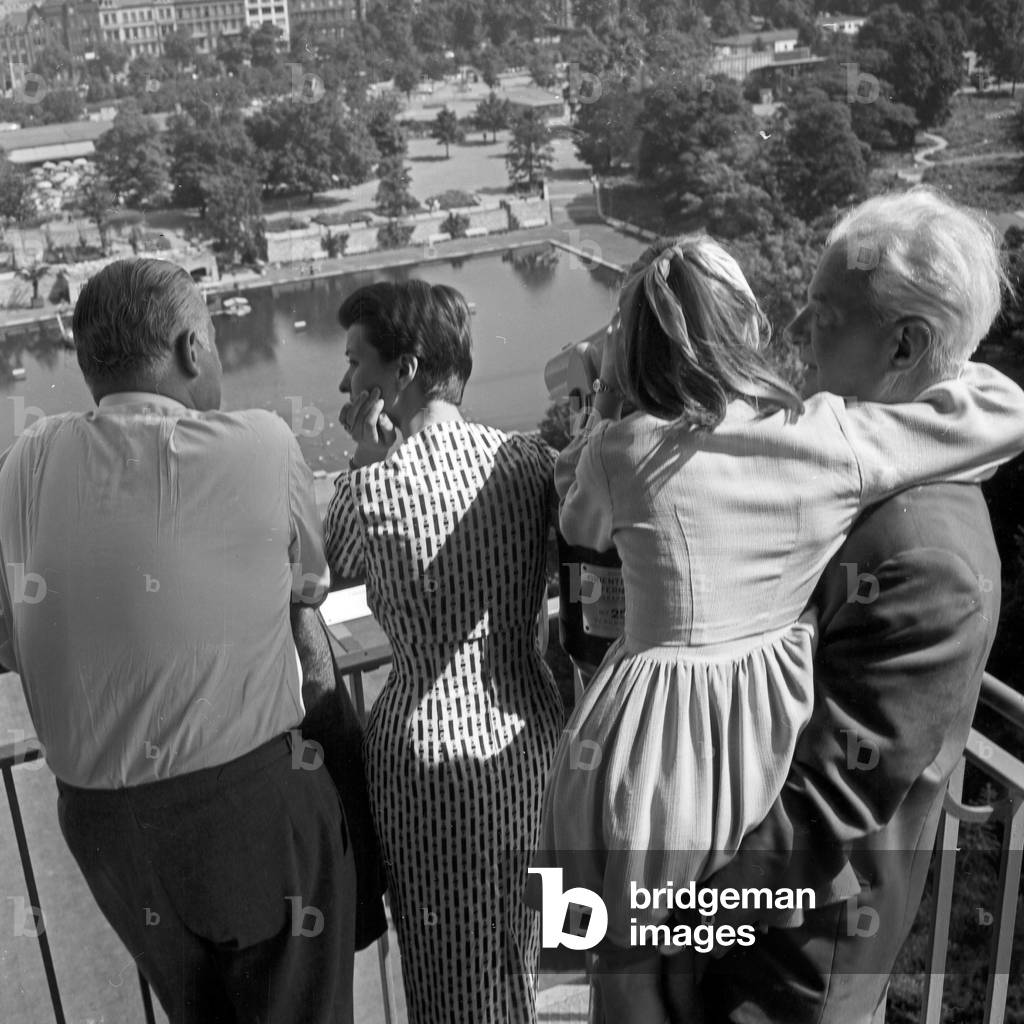 German television announcer Irene Koss with a child from Berlin on Philipsturm tower at Planten un Blomen public gardens in Hamburg, Germany 1950s