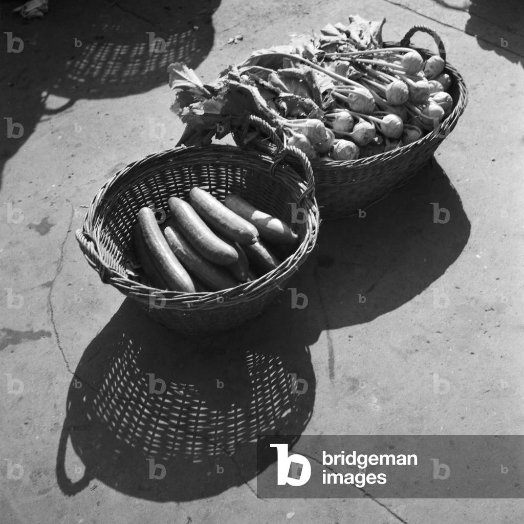 Cucumbers and kohlrabi of a vegetables booth at the main market of Stuttgart, Germany 1930s (b/w photo)