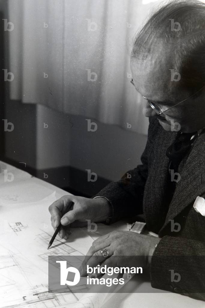 The architect Franz Ruff drawing and explaining the draft, sketch of a building, Germany 1930s (b/w photo)