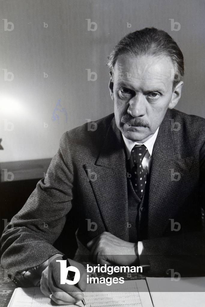 Portrait of one of the Diehl brothers and founders of the hedgehog character Mickie working on the skript of the animated movie The Race between the Rabbit and the Hedgehog, Germany 1930s (b/w photo)