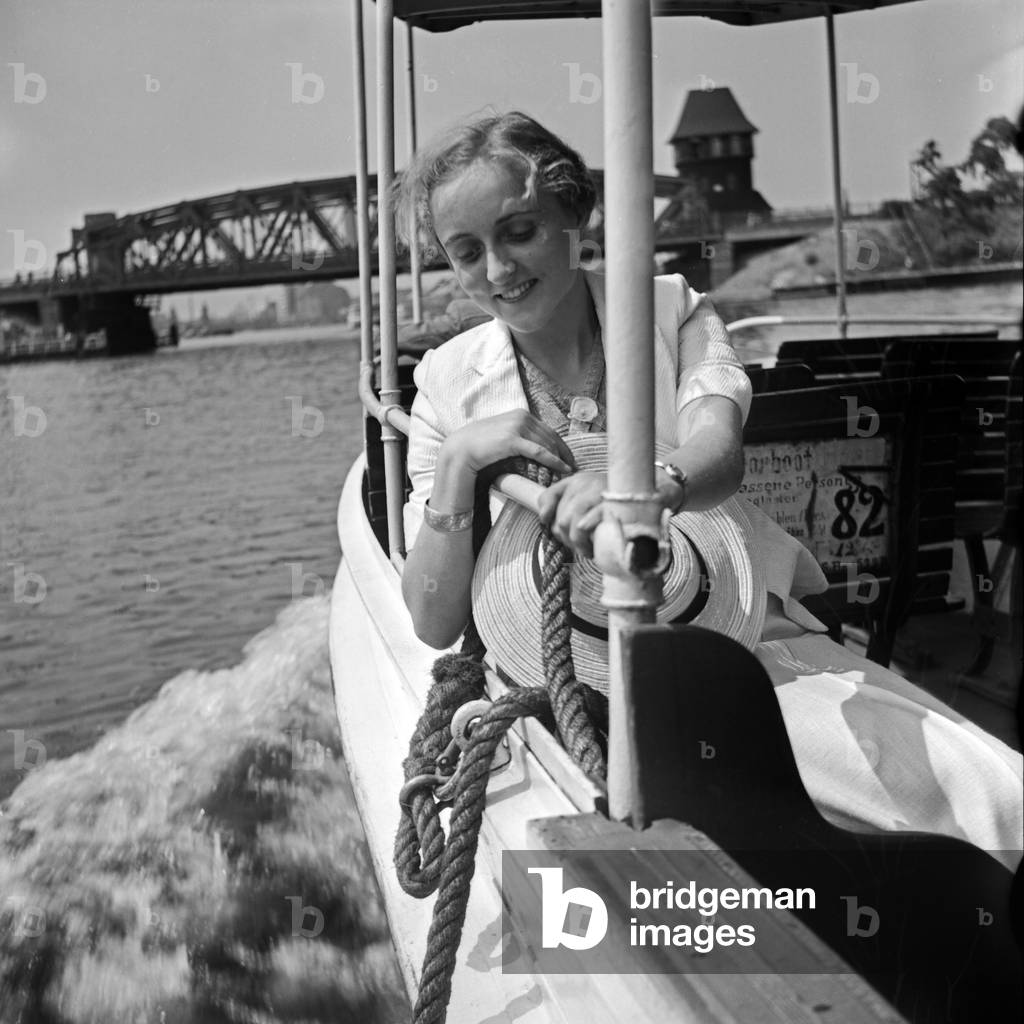 A young woman on a sightseeing tour on river Spree, Berlin, Germany 1930s (b/w photo)