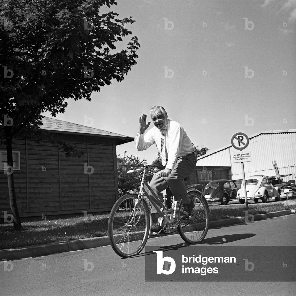 German manager and founder of TV lottery, Jochen Richert, relaxing while riding his bicycle, Germany 1960s