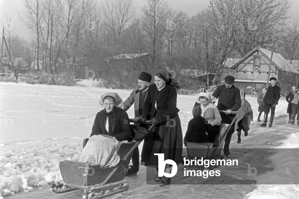 Families skating on a frozen lake at Spreewald area, Germany 1930s (b/w photo)