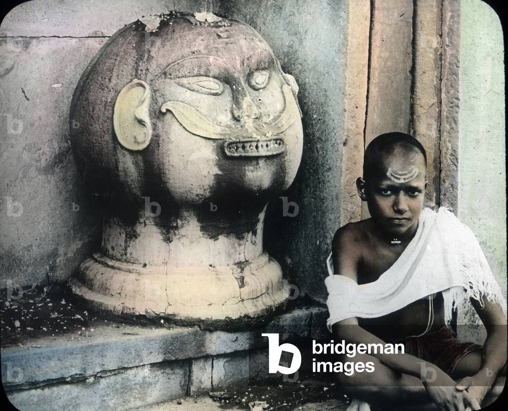 India, a boy next to a demon, image date: circa 1910. Carl Simon Archive