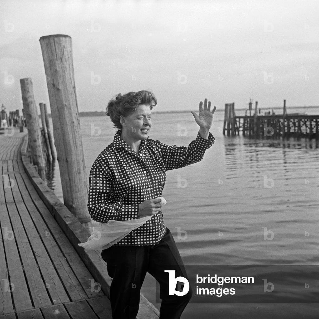 German actress Lotte Rausch wearing a plaid blouse on a boardwalk, Germany 1950s