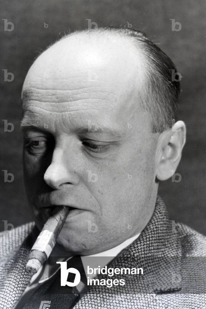 A man smoking a cigar for an advertising campaign, Germany 1930s (b/w photo)
