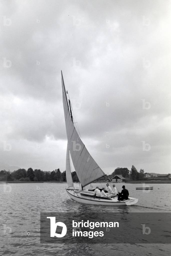A group of sailors floating over the Chiemsee in a boat, Germany 1930s (b/w photo)