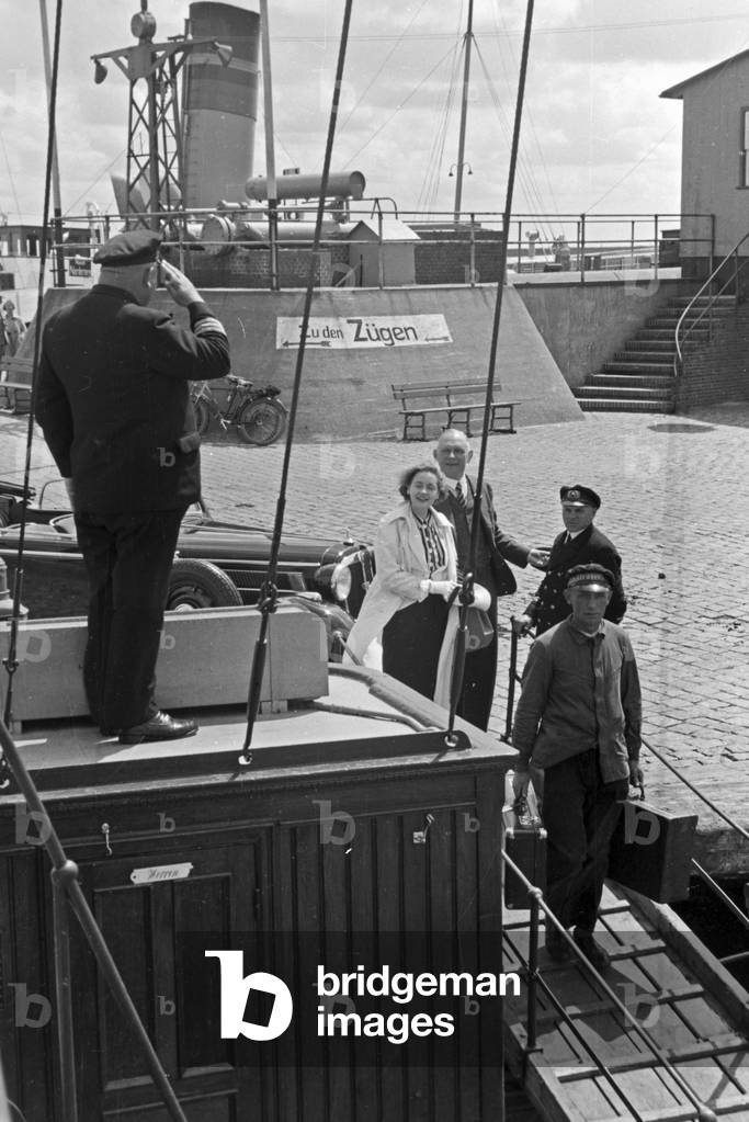 Passengers are saluted by the captain at the pier at Norddeich, Germany 1930s (b/w photo)