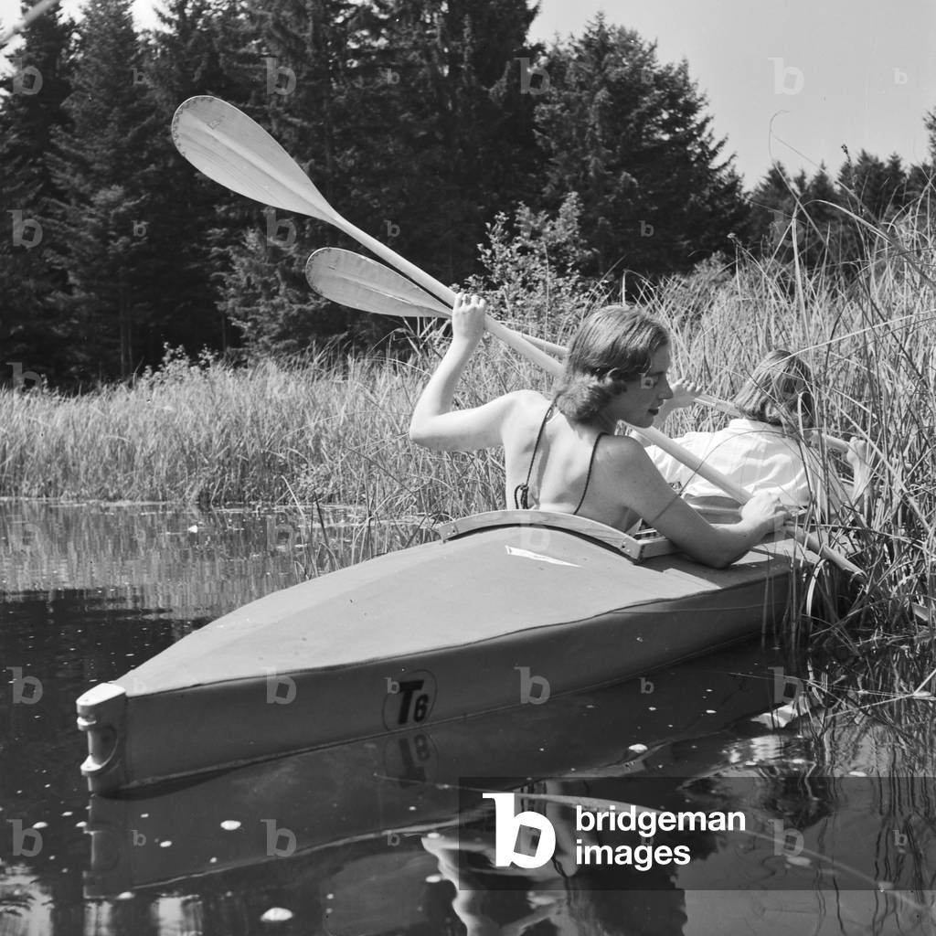 Two young women at a boardwalk on the shore of a lake in the Wachau area, Germany 1930s (b/w photo)