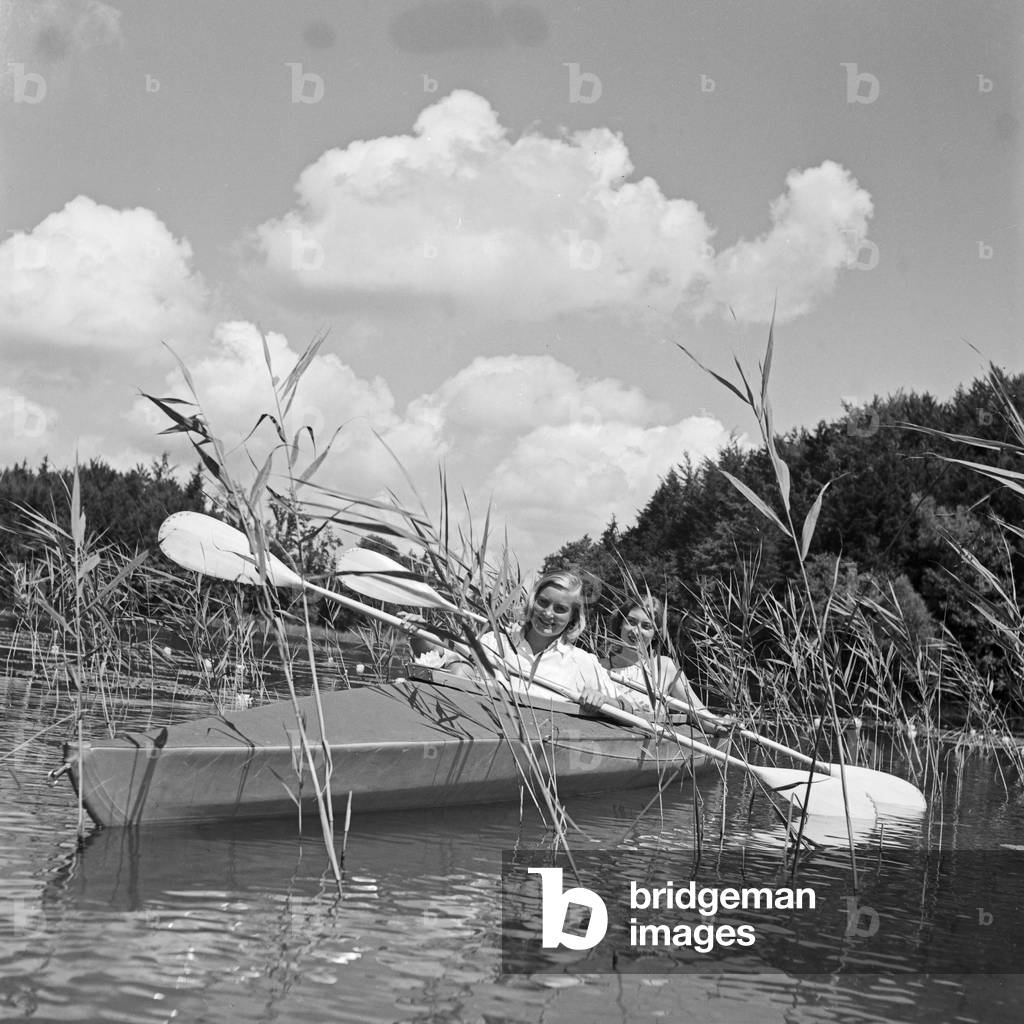 Two young women at a boardwalk on the shore of a lake in the Wachau area, Germany 1930s (b/w photo)