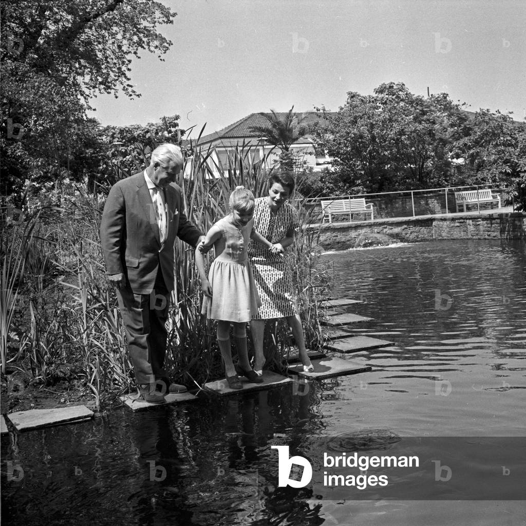 German television announcer Irene Koss with a child from Berlin at Planten un Blomen public gardens in Hamburg, Germany 1950s