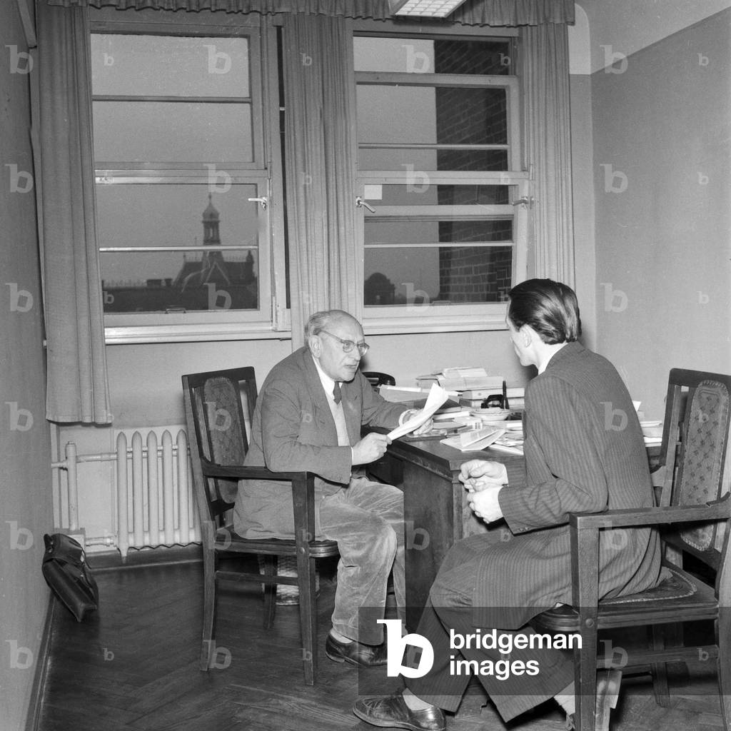 A young man getting some advice from an elder official, Hamburg 1954