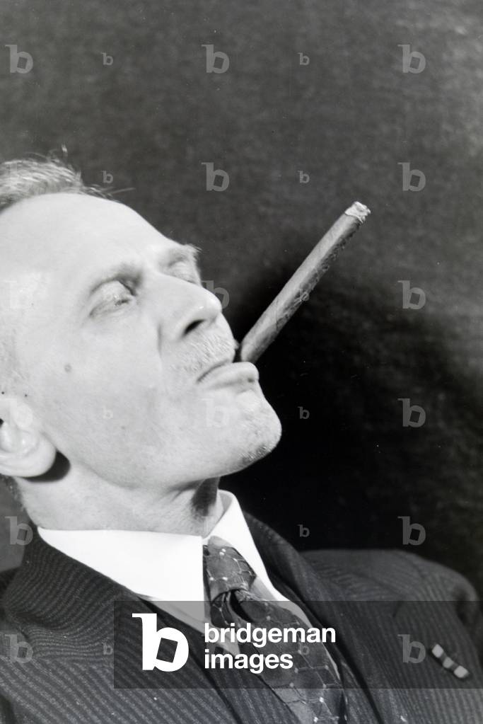A man smoking a cigar for an advertising campaign, Germany 1930s (b/w photo)