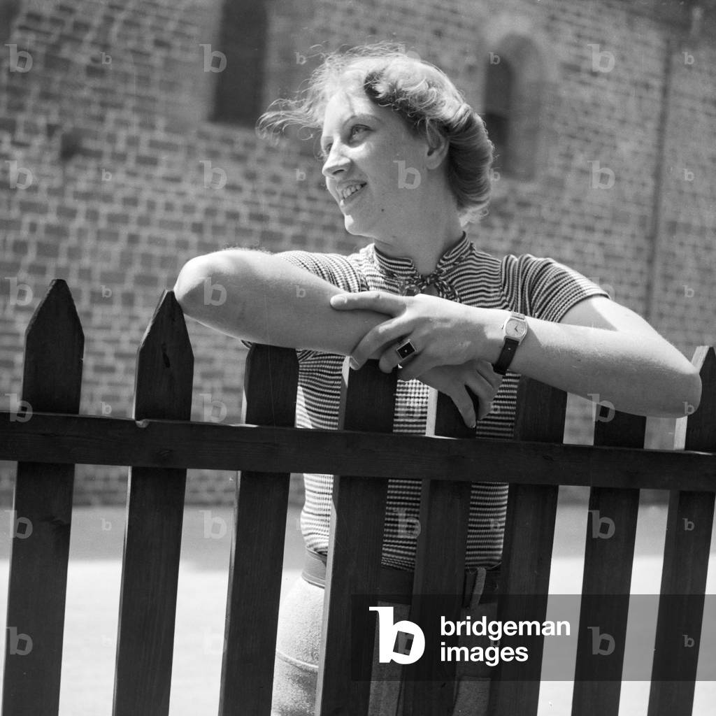 Woman by a fence, Germany 1930s (b/w photo)