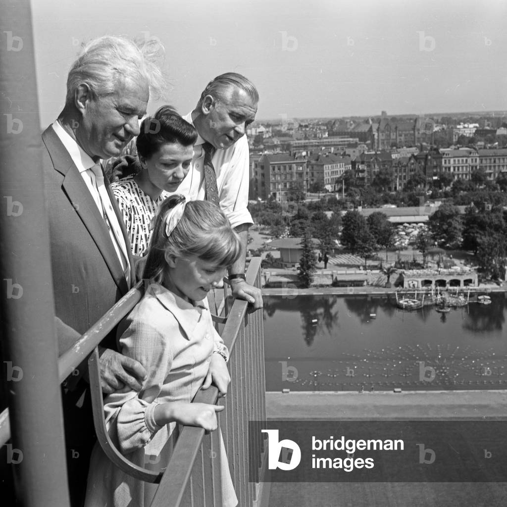 German television announcer Irene Koss with a child from Berlin on Philipsturm tower at Planten un Blomen public gardens in Hamburg, Germany 1950s