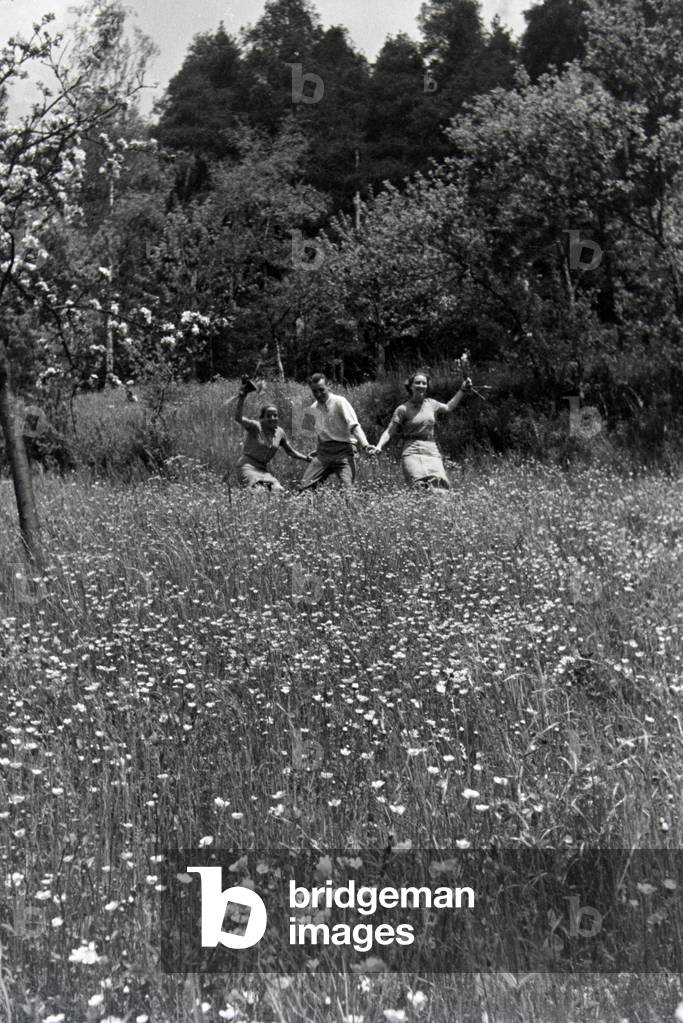 A young trio fooling around on a meadow in the Nagold Valley near Hirsau, Germany 1930s (b/w photo)