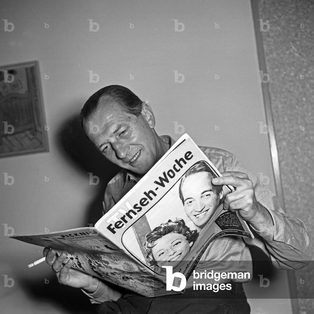 An editor reading a TV programm magazine, Germany 1950s