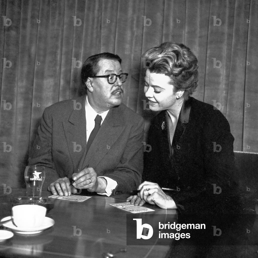 German actors Heidemarie Hatheyer and Paul Dahlke filling in their fee invoices at Hamburg, Germany 1956