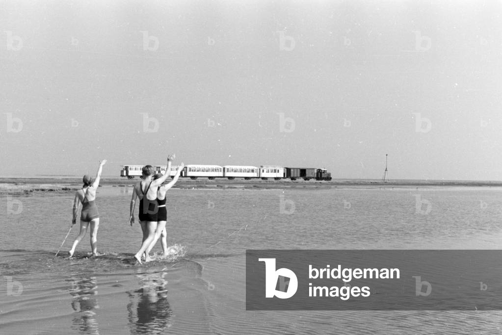 Holidaymakers on East Frisian island of Juist cheering to the island railway, Germany 1930s (b/w photo)