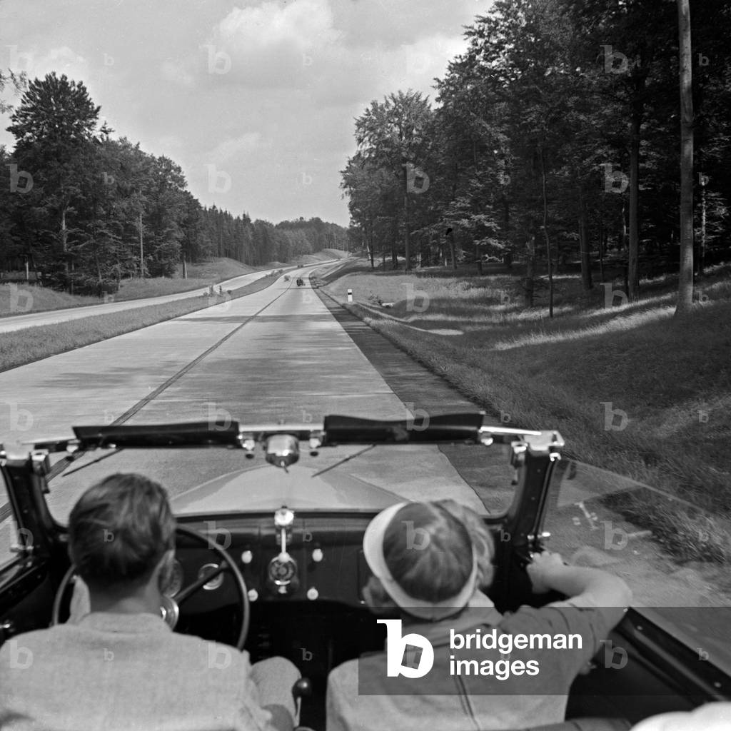 On the highway between Berlin and Stettin with the Ford V8 convertible, Germany 1930s (b/w photo)