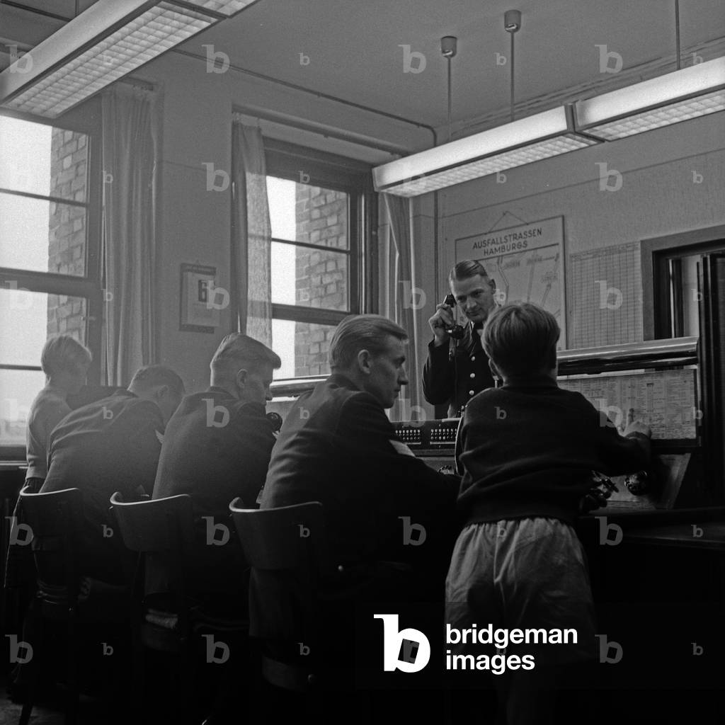Two children on a training day at the Hamburg police, here at the telephone central, Germany 1950s