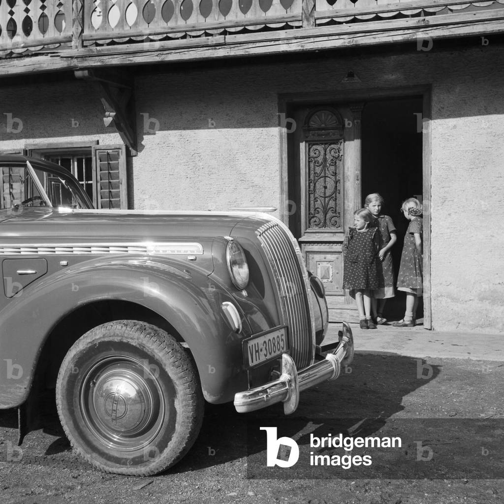 An Opel model Admiral in front of an elementary school at Austria, 1930s (b/w photo)