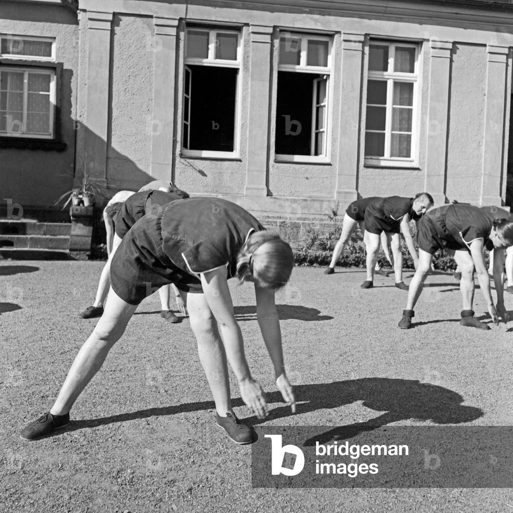 Women doing exercises in the morning at a mother and child recreation home at Tabarz, Thuringia, 1930s (b/w photo)