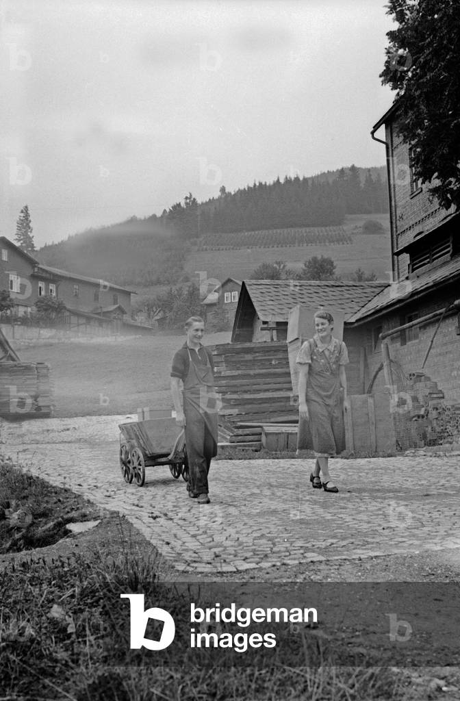 Apprentice boy and forewoman of the porcellain factory at Graefenthal, Thuringia, Germany 1930s (b/w photo)