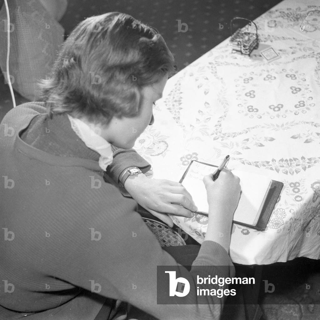 A young girl writing in her diary, Germany 1955