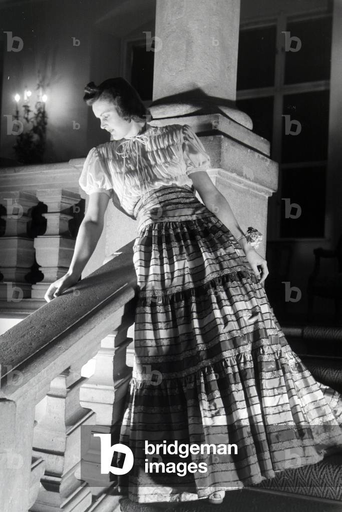 A model is presenting a folkloristic dress, on the occasion of the Wiener Modewoche in the house of fashion 