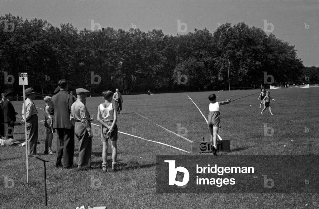A boy doing a fry run in angling at a lawn, Germany 1930s (b/w photo)