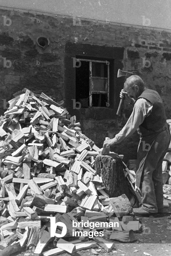 A man chopping wood, Hirsau, Black Forest, Germany 1930s (b/w photo)