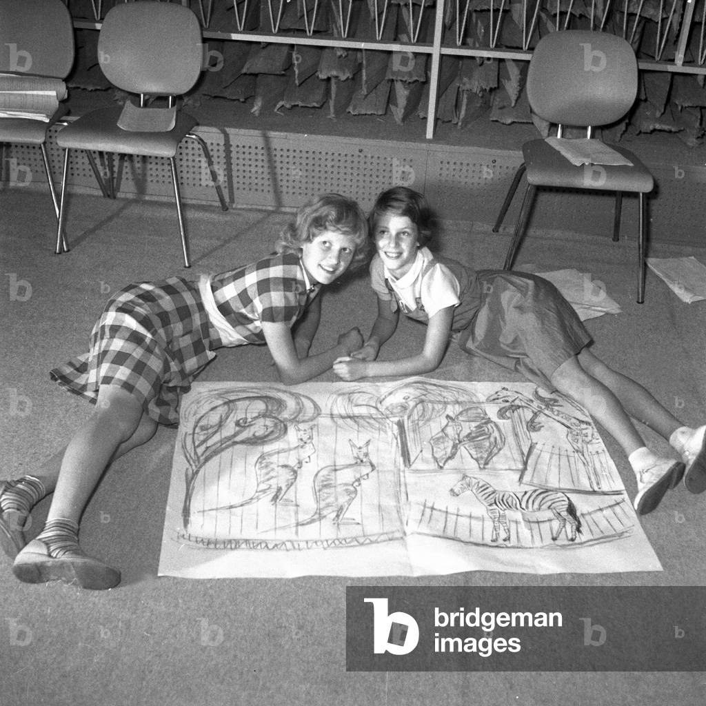 Two girls lying on the ground with a scribble for a stage decoration, Hamburg 1954