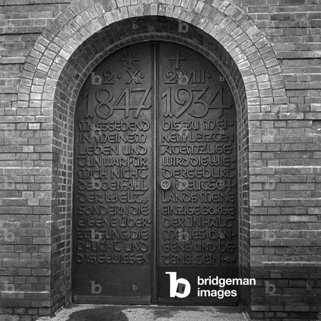 Entrance to the tomb with a quote of Paul von Hindenburg at the inner courtyard at the Tannenberg monument near Hohenstein in East Prussia, Germany 1930s (b/w photo)