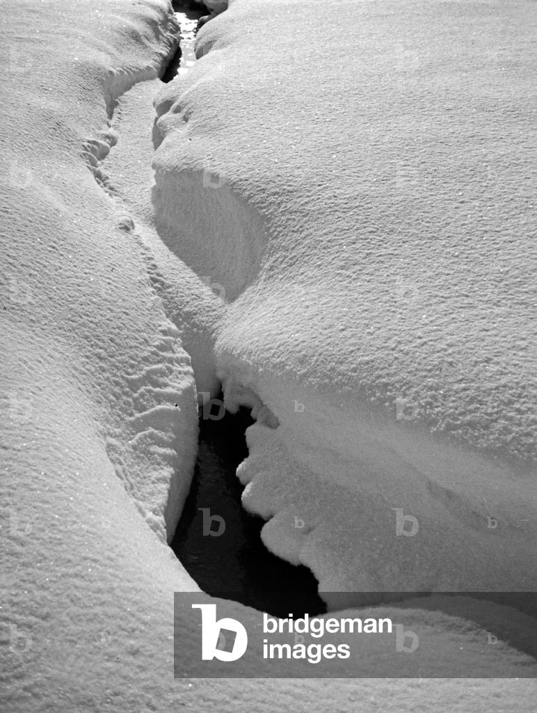Snow covered creek in wintertime in East Prussia, 1930s (b/w photo)