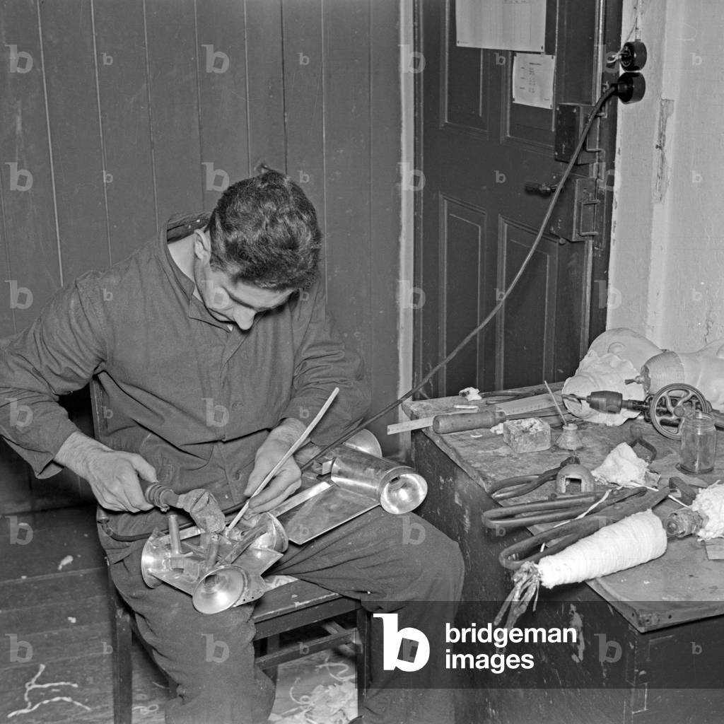 Fine tuning at a torse of one of the Kaethe Kruse display dummies at Bad Koesen, Germany 1930s (b/w photo)