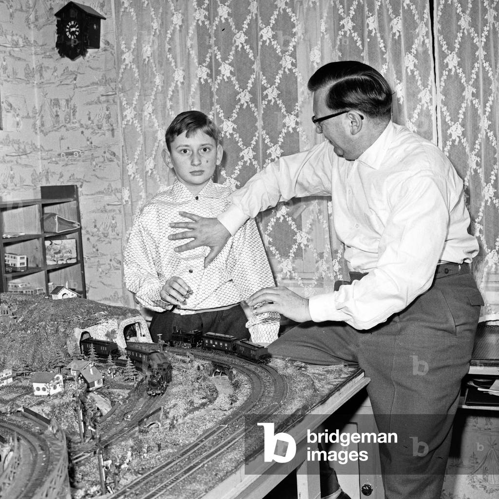 That's the game: the son gets a model train and his father is playing with it, Germany 1960s