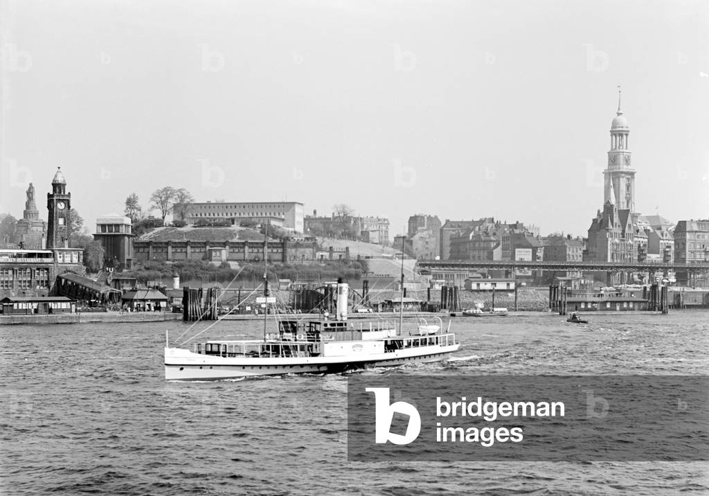 Germany, Hamburg, view to the Landungsbruecken (landing stage) with Bismarck memorial, the youth hostel and the St. Michael's Church, 1950s (b/w photo)