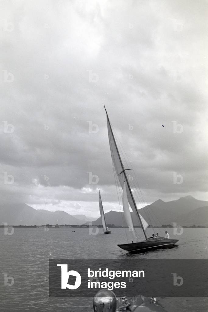 Sailing boats floating over the Chiemsee with hoisted sails, Germany 1930s (b/w photo)