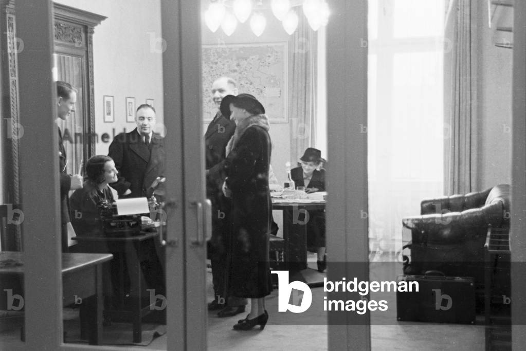 Travellers and staff members at a huge office of a travel agency in Berlin, Germany 1930s (b/w photo)