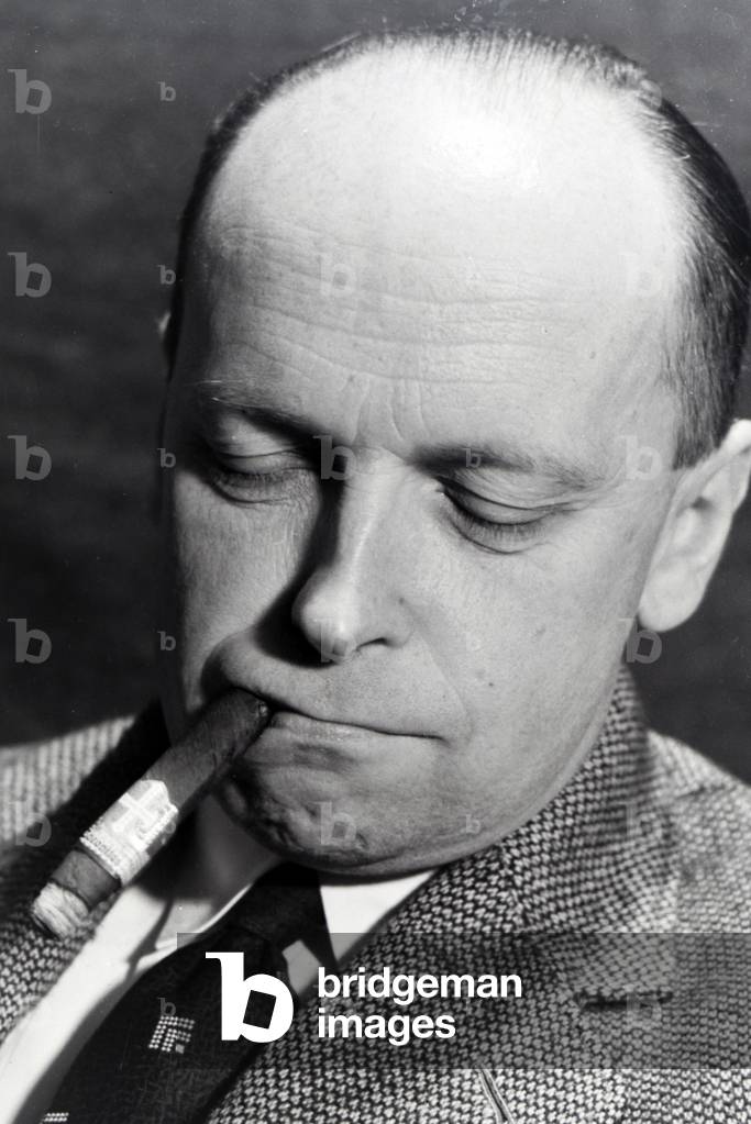 A man smoking a cigar for an advertising campaign, Germany 1930s (b/w photo)